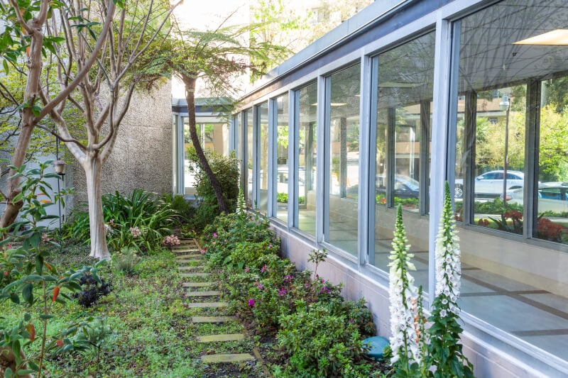 Garden outside a glass hallway at Piedmont Gardens