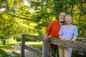 Senior couple smiling on bridge