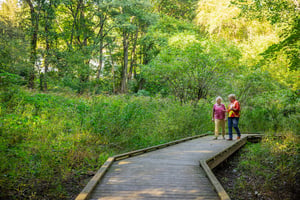 Two women walking on the board walk at Springhouse