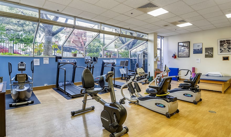 Gym equipment, including treadmills and stationary bikes, at the fitness center at Piedmont Gardens