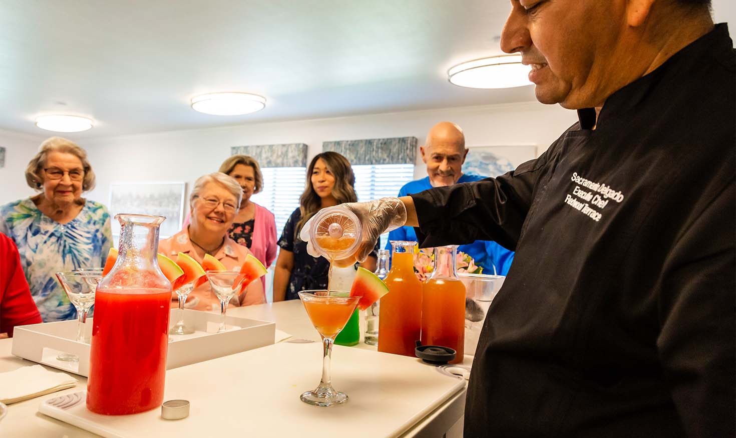 Redwood Terrace chef pouring cocktails for a group of seniors