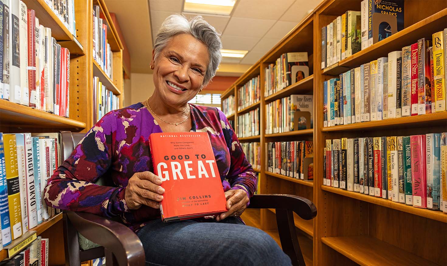 Senior woman holding up the book 