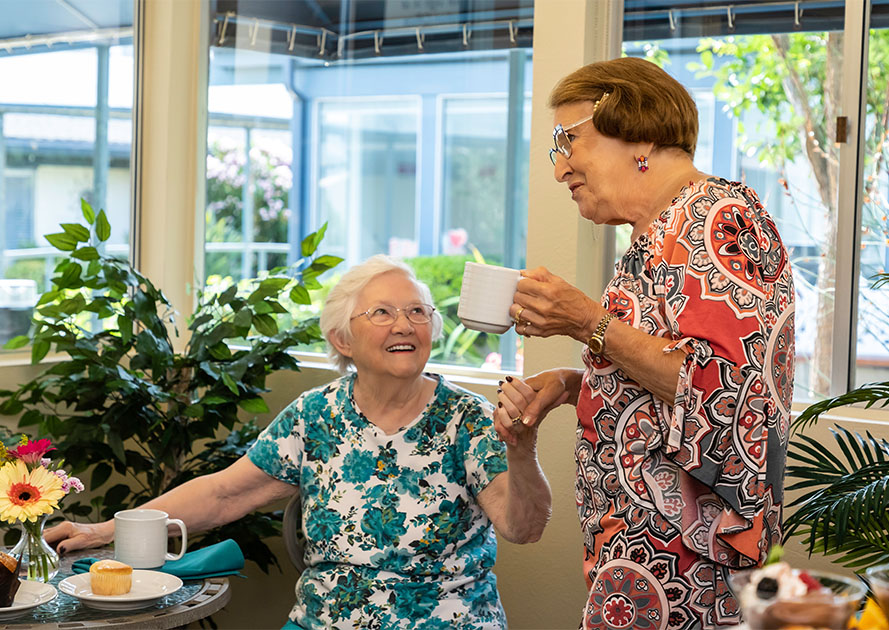 Senior women enjoying coffee and breakfast in the cafe at Redwood Terrace