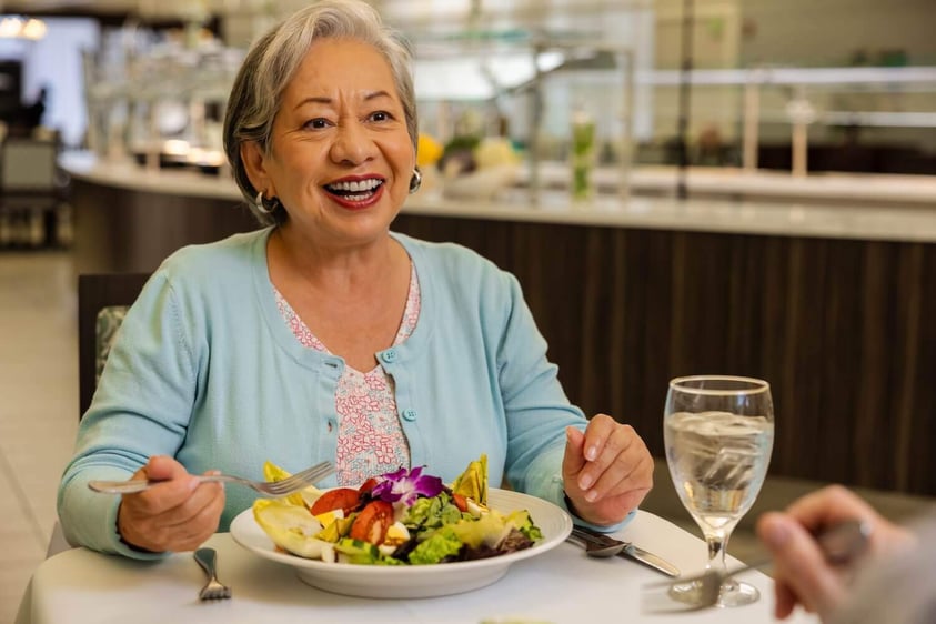 close up on woman eating salad