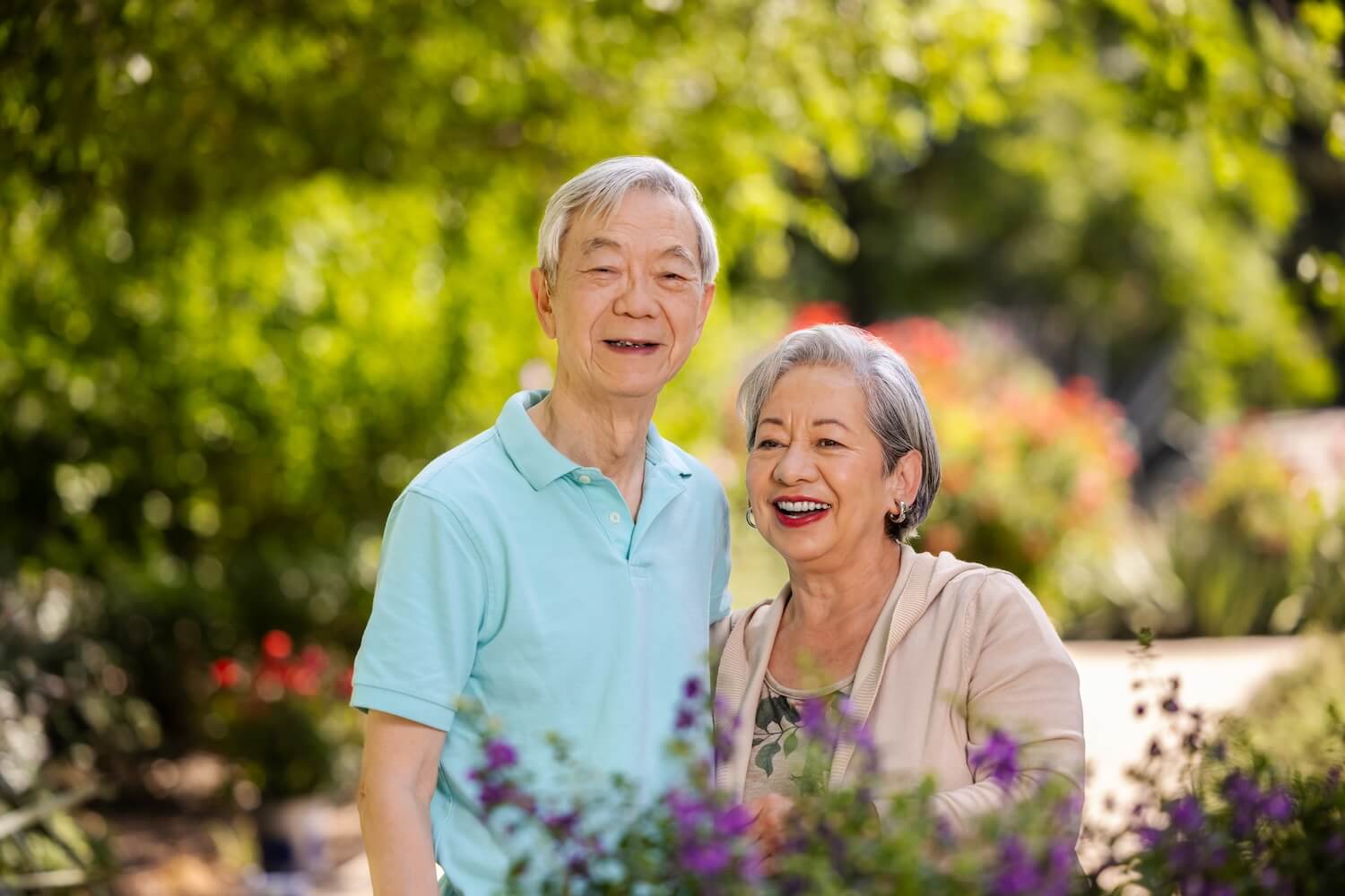 smiling couple in a flower garden