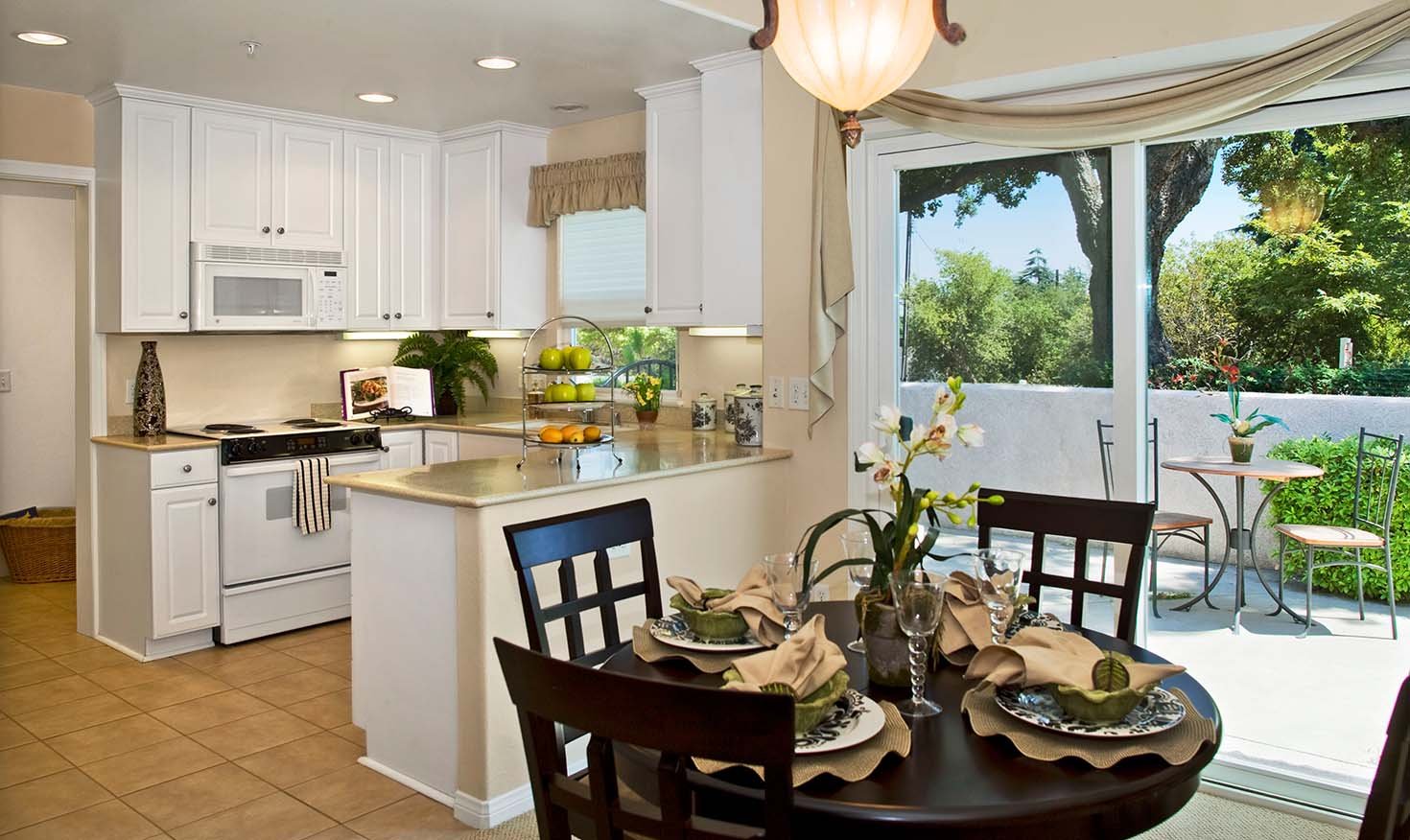 Kitchen and dining area with a patio outside sliding glass doors of an apartment at Royal Oaks 