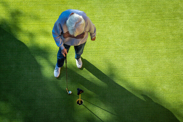 Overhead photo of a senior on the putting green at Royal Oaks