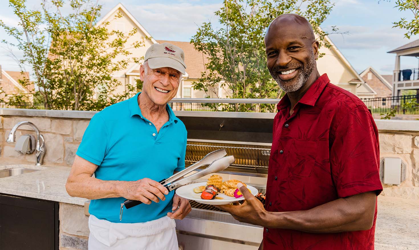 Two senior men grilling on a barbecue