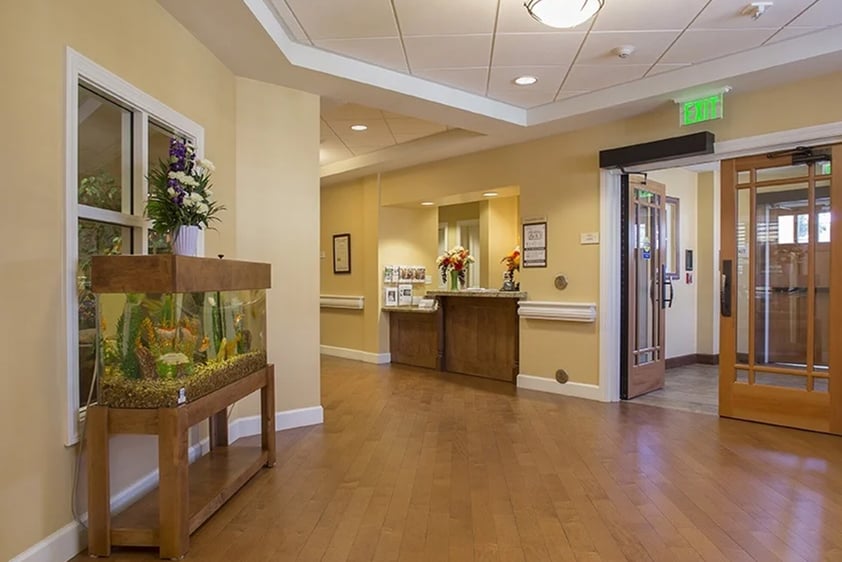 Reception area with desk and fish tank at The Terraces at Los Altos