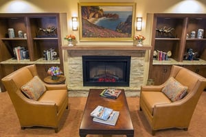 Two armchairs near fireplace at The Terraces at Los Altos