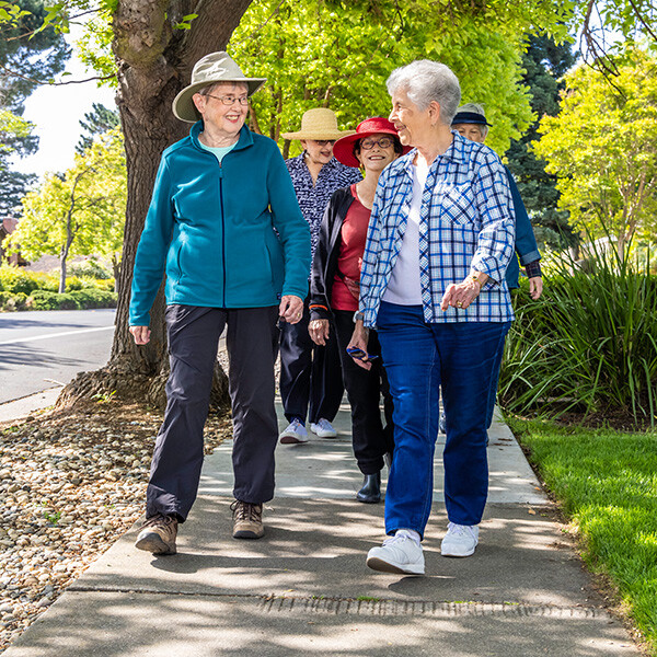 Group of senior friends walking down the sidewalk