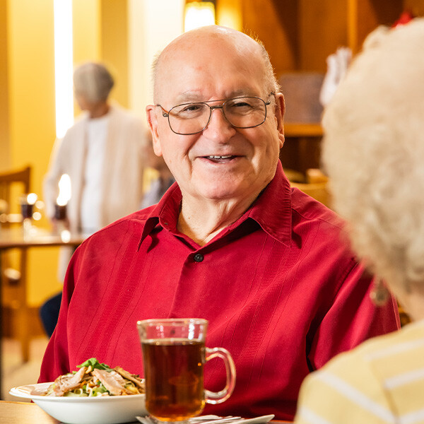 Senior man enjoying lunch in The Terraces at Summitview dining room