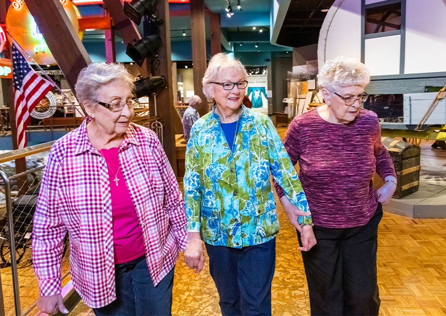 Three senior women walking