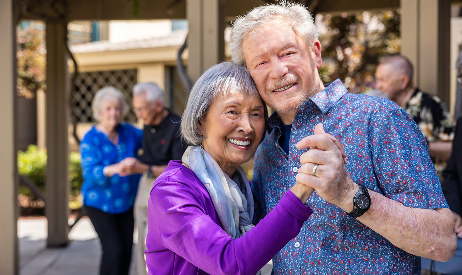 Senior couples dancing on a patio