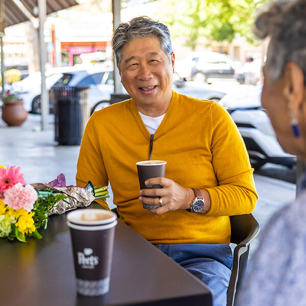 Senior man enjoying a cup of coffee on a patio