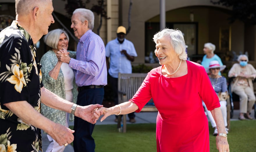 Seniors dancing on the lawn at The Terraces of Los Gatos