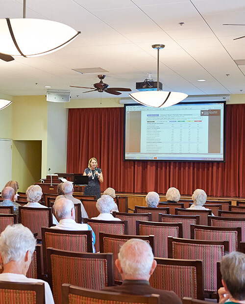 Woman giving a lecture to a group of seniors