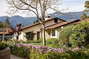 Exterior of Valle Verde residences surrounded by flowers and trees