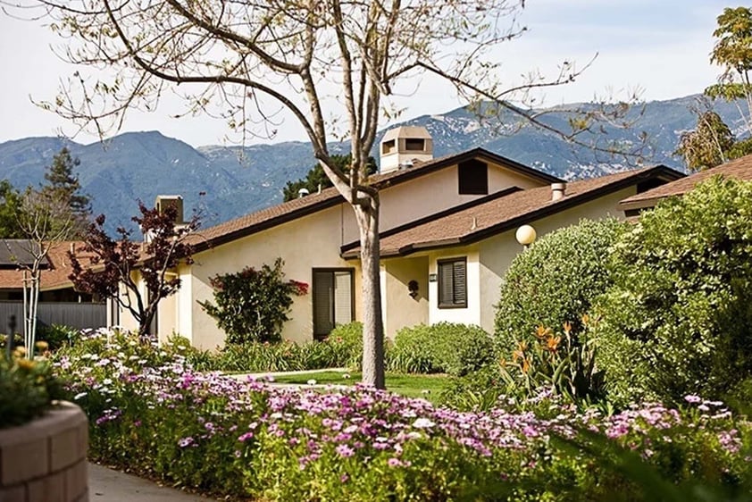 Exterior of Valle Verde residences surrounded by flowers and trees