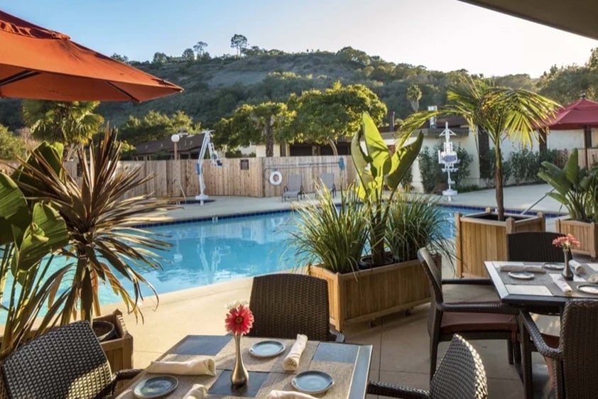 Heated outdoor pool at Valle Verde with poolside dining area