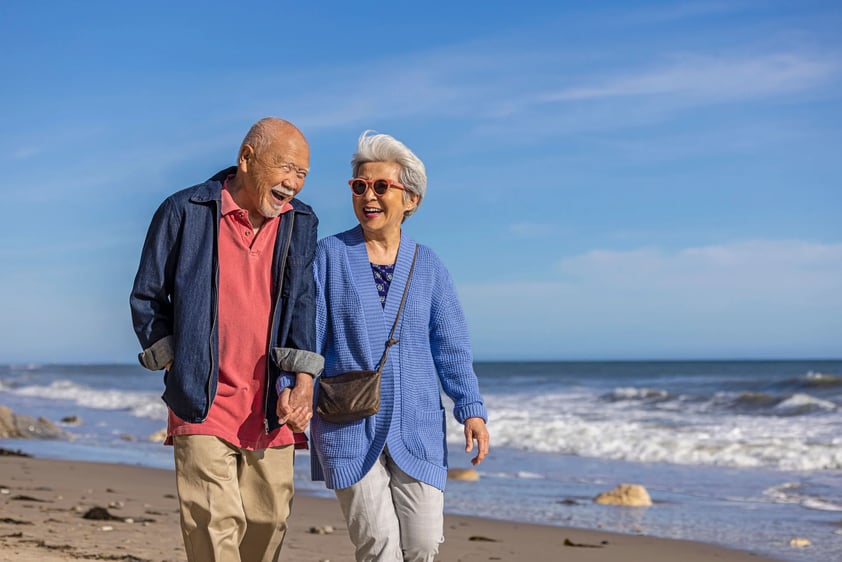 Senior couple walking on the beach