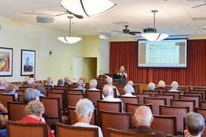 Woman giving a lecture to a group of seniors