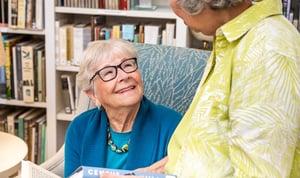 Two senior women inside the library