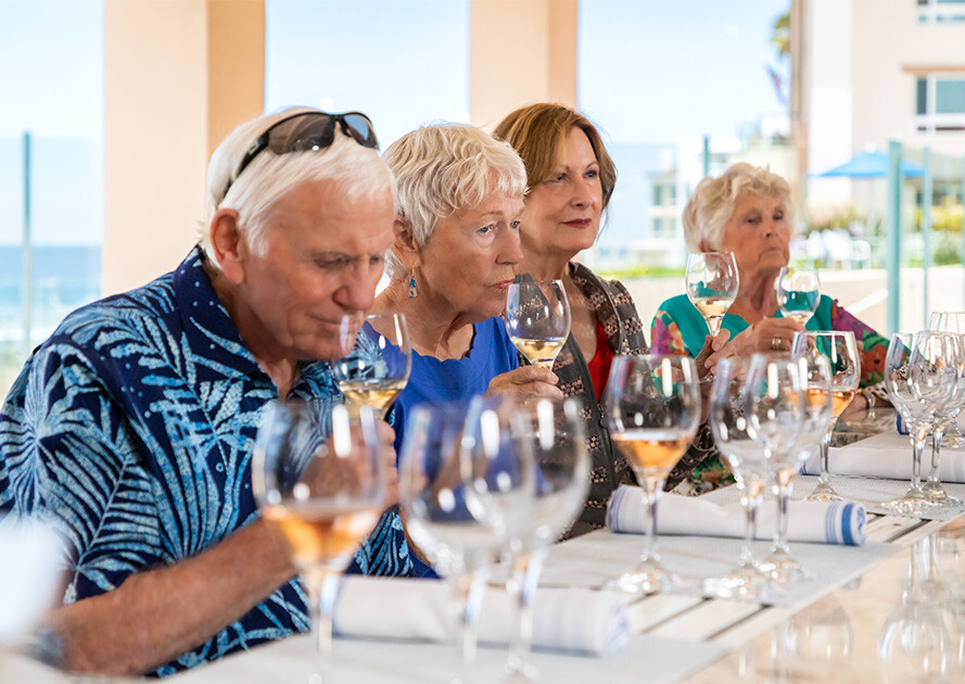 Four seniors at a wine tasting event