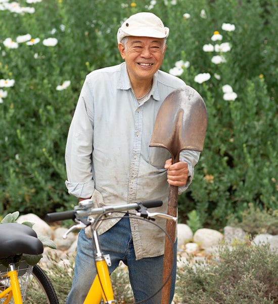 Danny standing next to a yellow bicycle