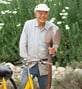 Danny standing next to a yellow bicycle