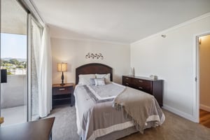 Bedroom with dark wood furniture in an apartment at Piedmont Gardens