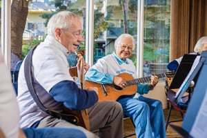 Group of seniors playing guitar and singing