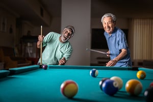 Two senior men playing pool