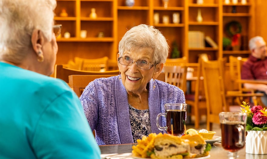 Senior woman eating lunch in The Terraces at Summitview dining room