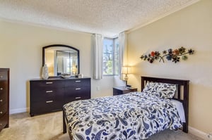 Bedroom with dark wood furniture in an apartment at Piedmont Gardens