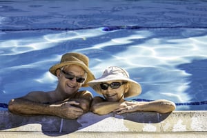 An elderly couple enjoying the pool