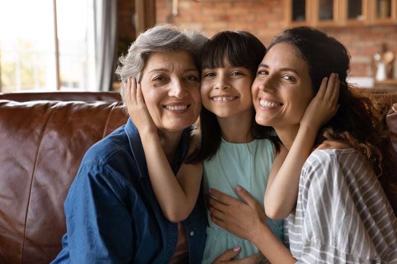 Three generations of women smiling together