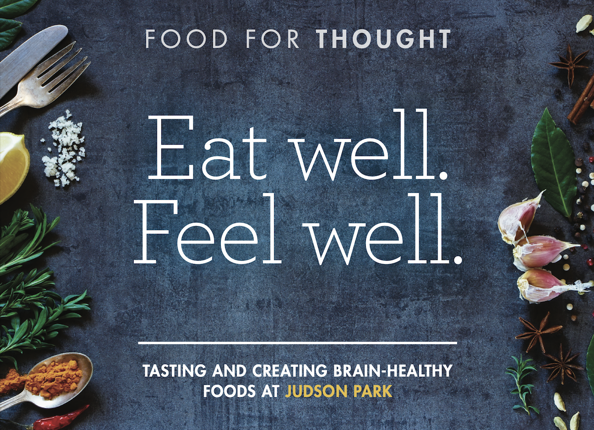 Food-themed image with the text "Eat well. Feel well." surrounded by herbs, spices, and utensils on a dark slate background.