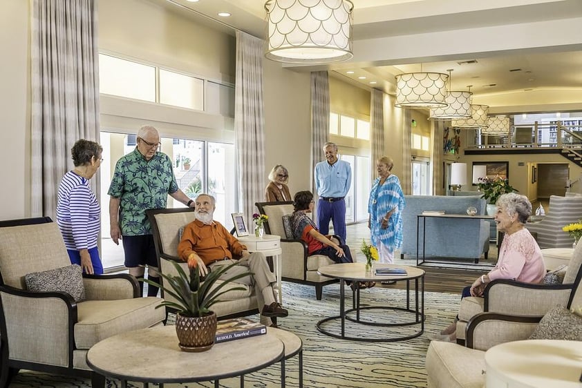 Group of seniors chatting in a common seating area of White Sands