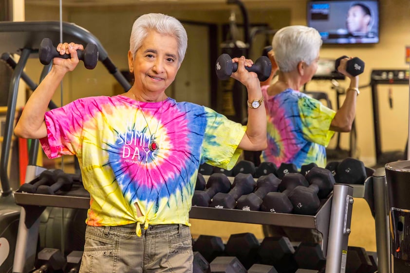 Senior woman working out in fitness center