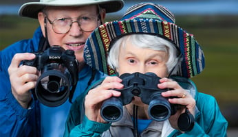 Bryce and Ann holding binoculars