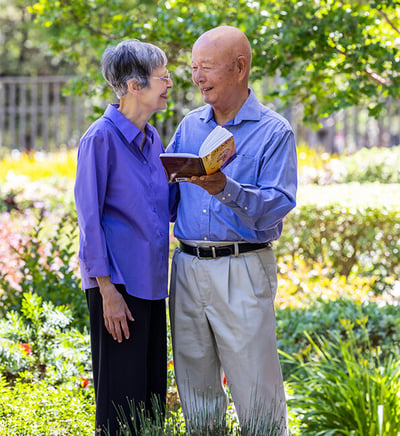 Hi-Dong and Phyllis reading a book in the garden