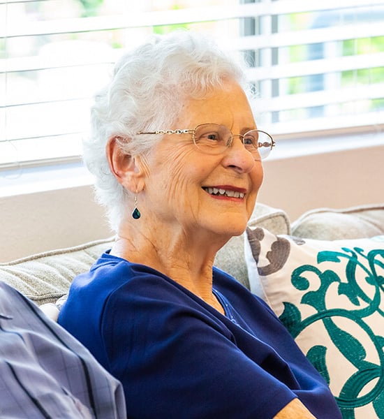 senior smiling in her living room