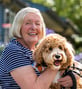 senior petting her dog 