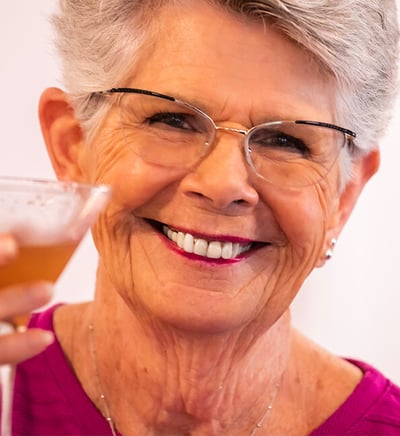 senior smiling with a cocktail