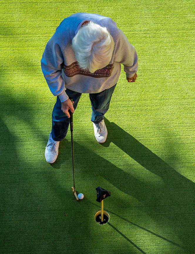 Overhead photo of a senior on the putting green at Royal Oaks