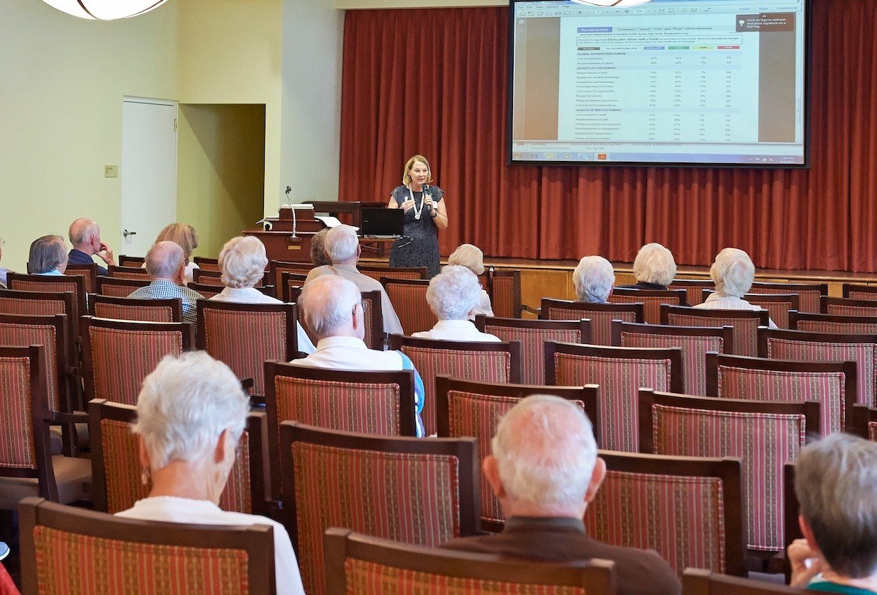 Woman giving a lecture to a group of seniors