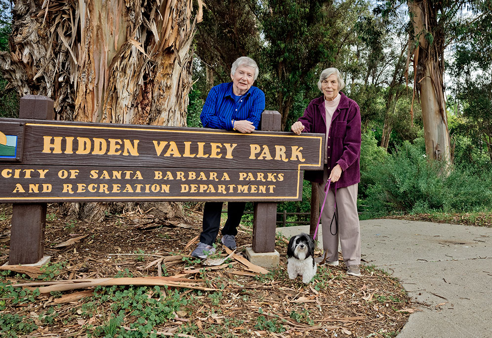 Jo Ann and Pat standing outside with their Havanese dog, Darcy