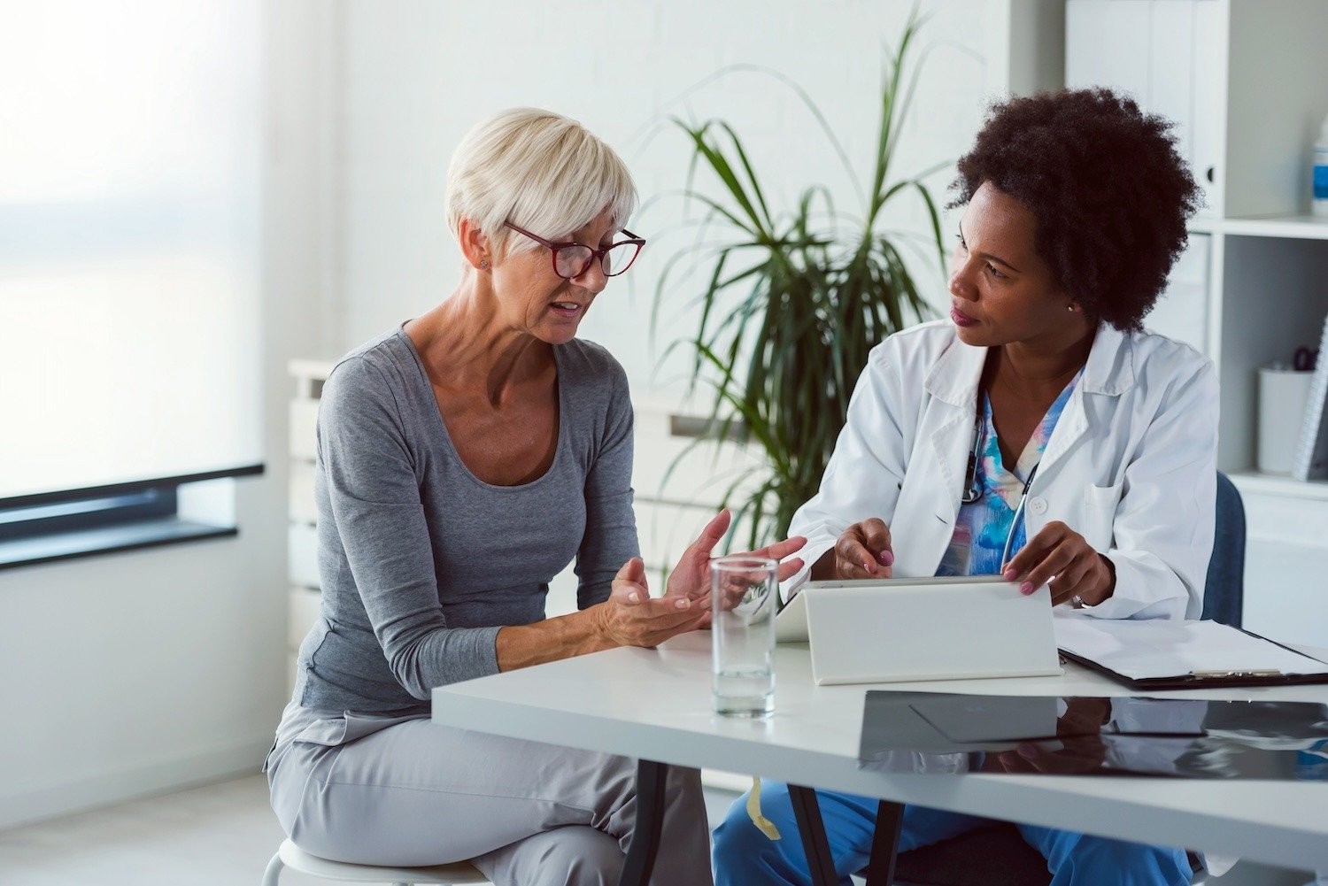 woman speaking with doctor in office setting