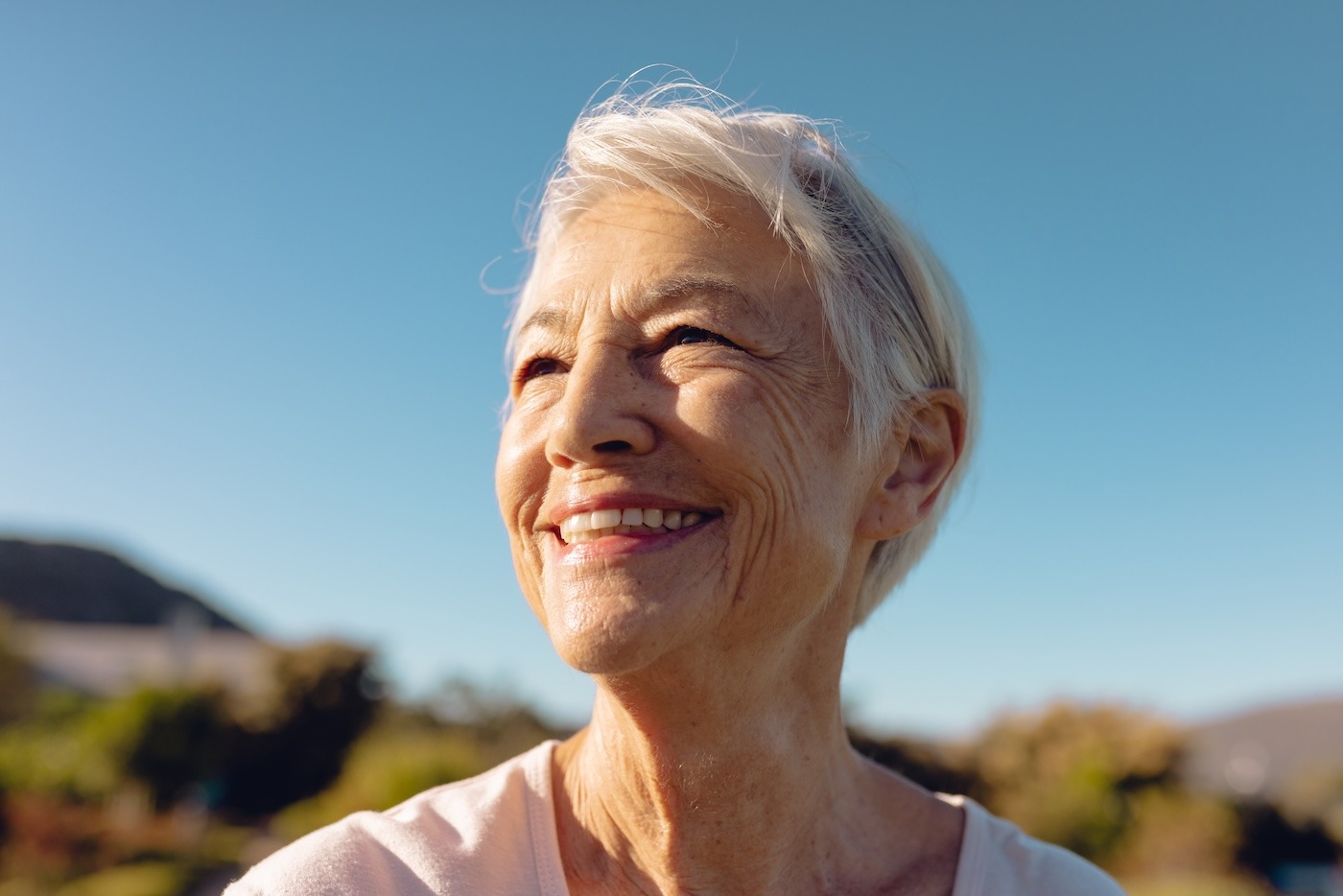 woman smiling outside with blue sky